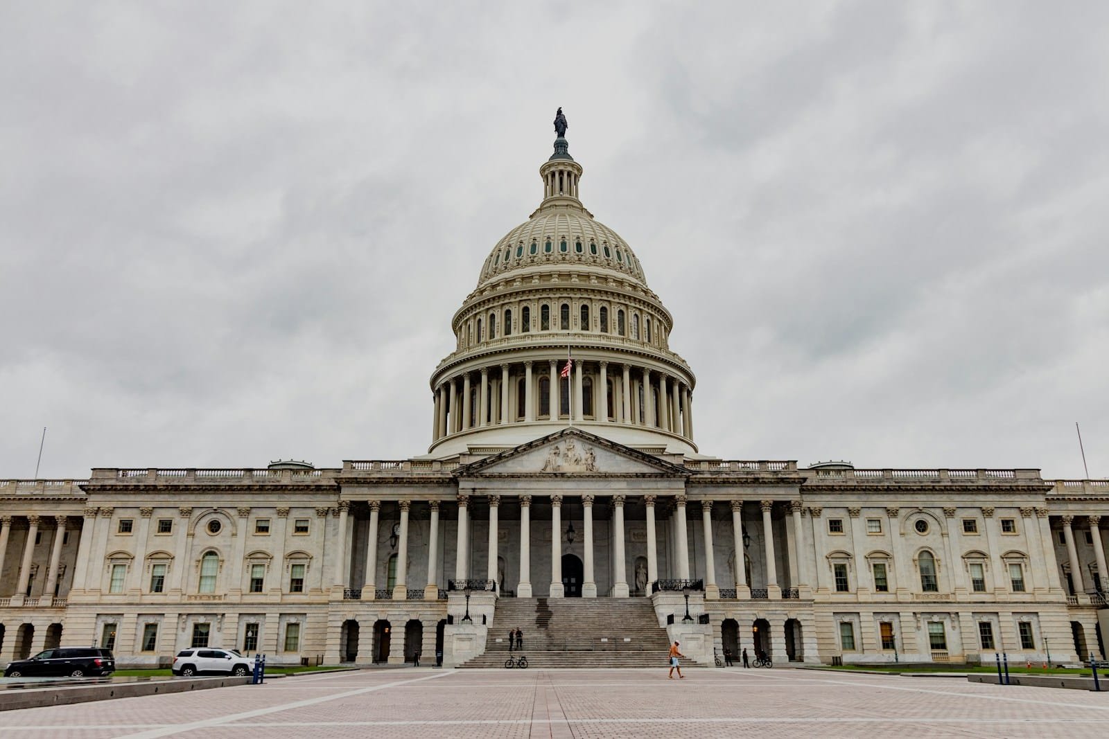 The united states capitol building stands under a cloudy sky.